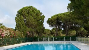 A rectangular swimming pool with a tiled deck in the foreground. - Seemingly cosy, close to the beach and in the heart of the golf course (Saint-Cyprien)