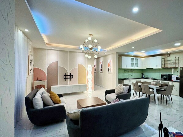 Deluxe Apartment, City View | Living area | Flat-screen TV