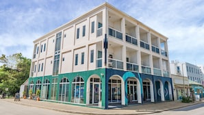 A multi-story building with a flat facade, large windows, and a green and white color scheme. - Kralendijk Boutique Hotel (Kralendijk)