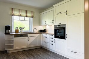Enjoy cooking in this well-equipped kitchen with a dishwasher, stove, and microwave.