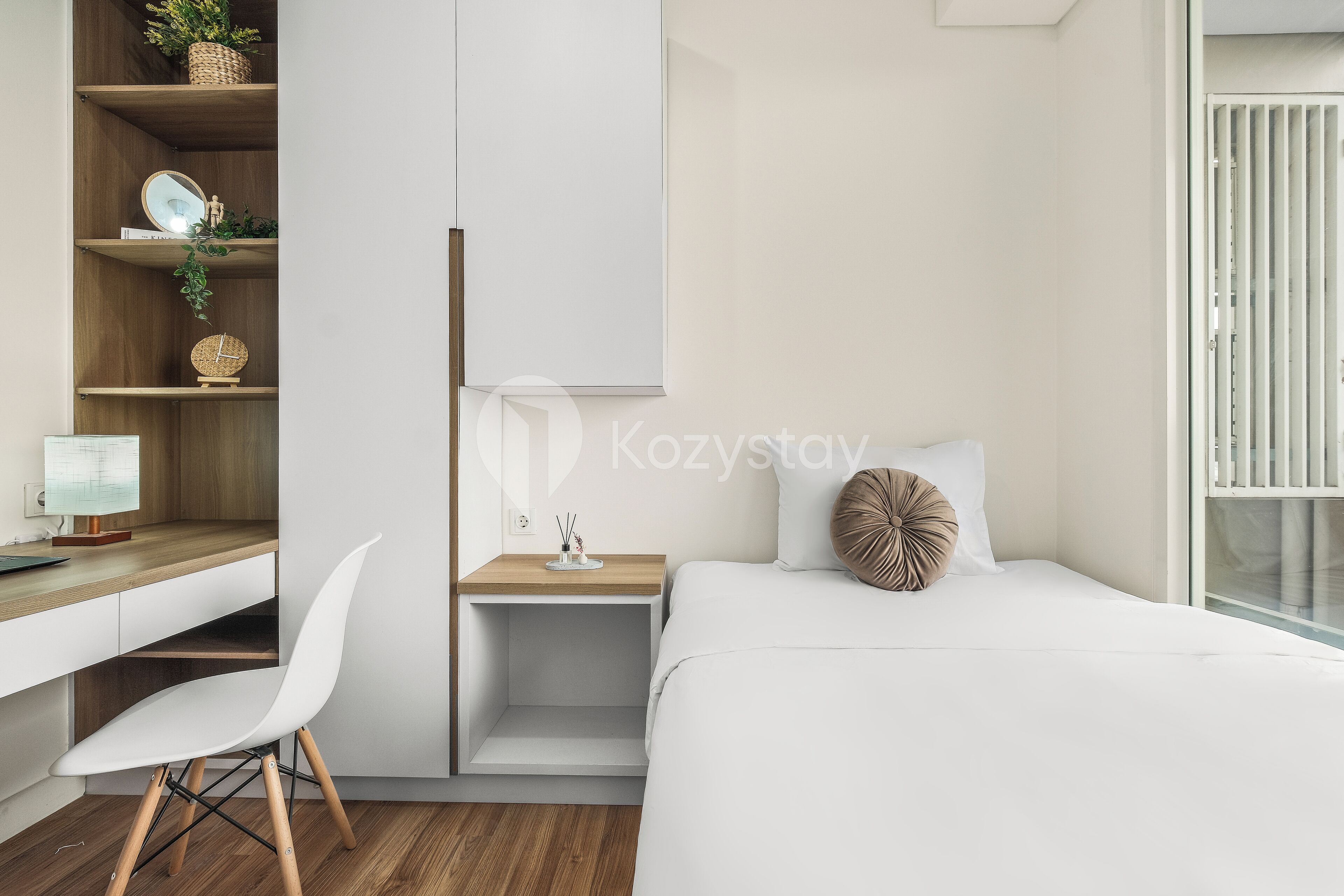 A modern bedroom with a bed, a desk, and a chair.