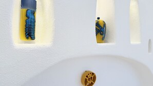 A white wall with three recessed niches containing decorative objects. - [Green Hotel] Rural hotel double rooms (Orosei)