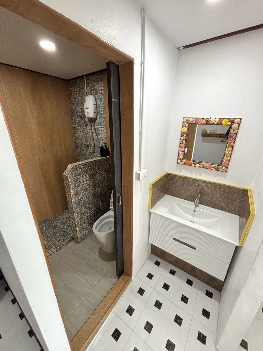 A bathroom with a shower, toilet, and sink.