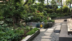 A garden pathway with stepping stones and a brick border.