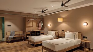 A modern hotel room with two beds, a desk, a wardrobe, and a ceiling fan. - Minimalist - The Varanasi Edit (Varanasi)