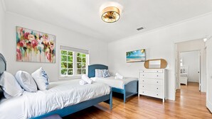 A bedroom with a bed, a desk, a chair, and a window. - Welcome to Your West Palm Beach Getaway! (West Palm Beach)