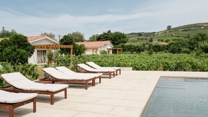 A pool area with lounge chairs and a view of a vineyard. - Imago Houses 3 - by MET (Lamego)