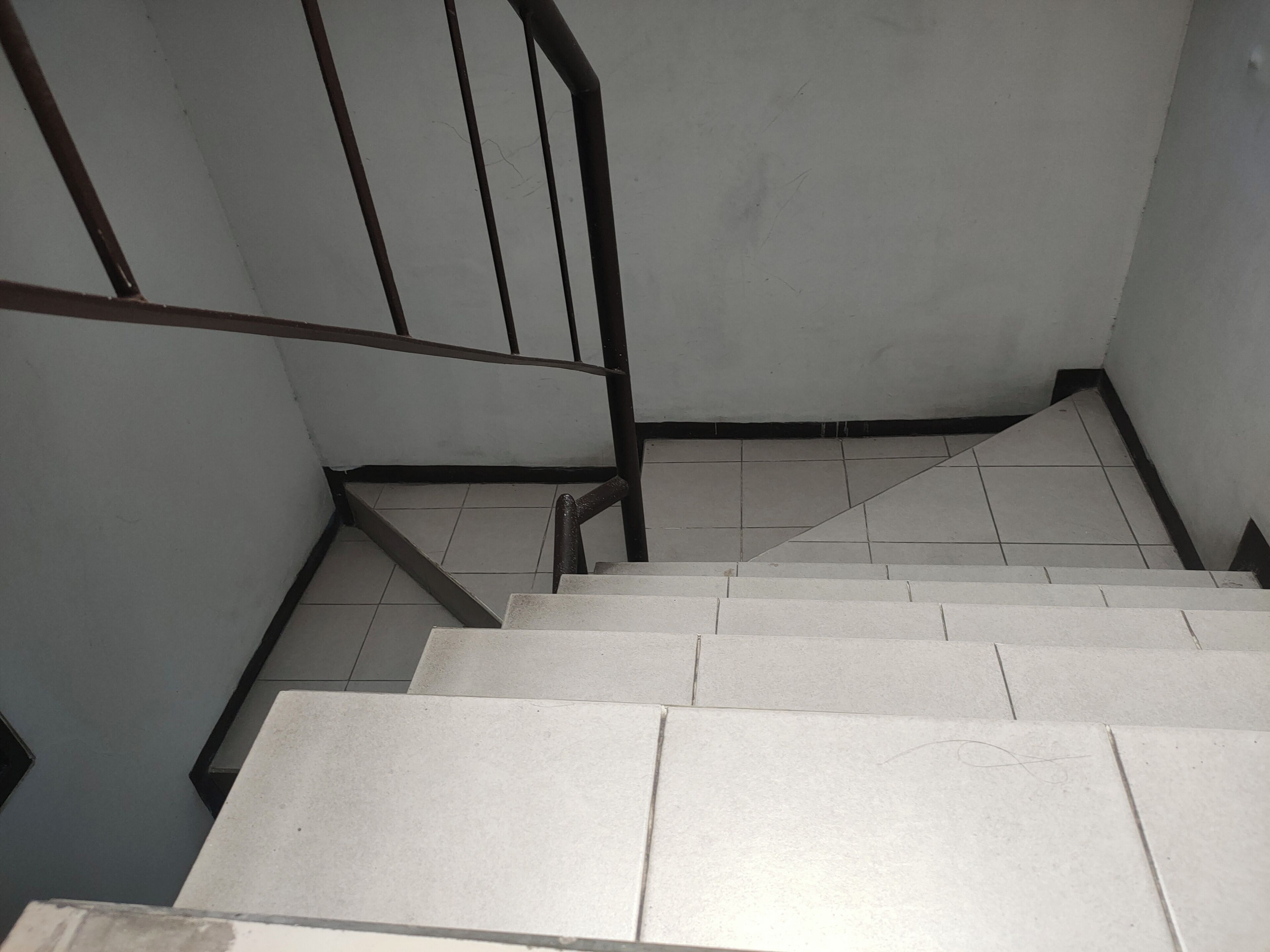 A staircase with white steps and metal railings.