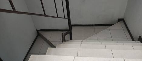 A staircase with white steps and metal railings.