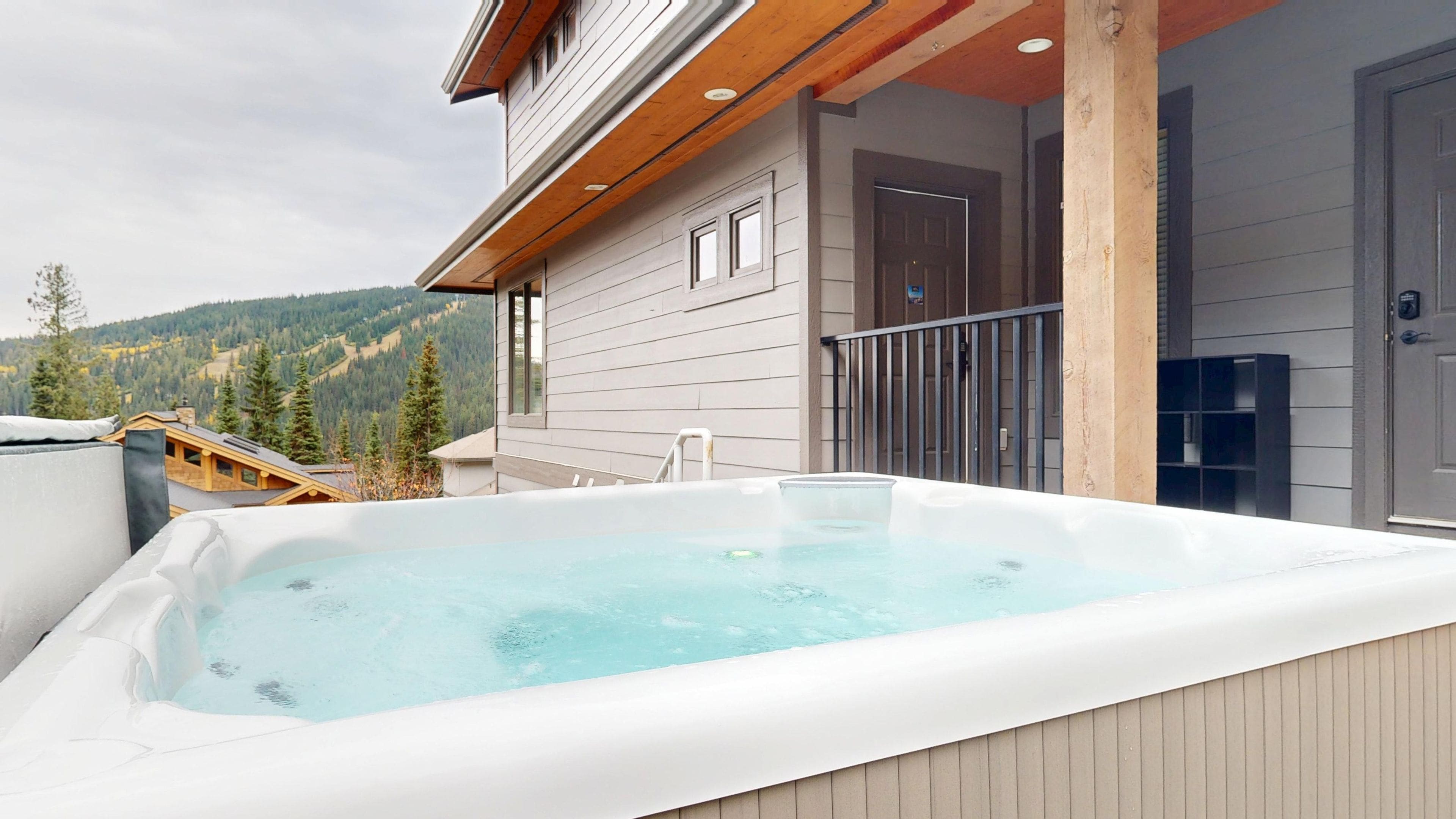 A hot tub on a balcony with a mountain view.