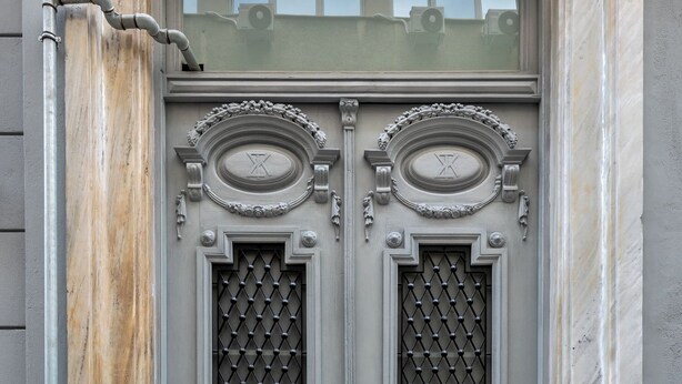 A double door with intricate carvings and a keypad lock. - J&A Luxury Residence (Athens)