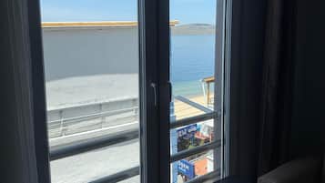 Family Triple Room, Sea View | Minibar, free WiFi, bed sheets