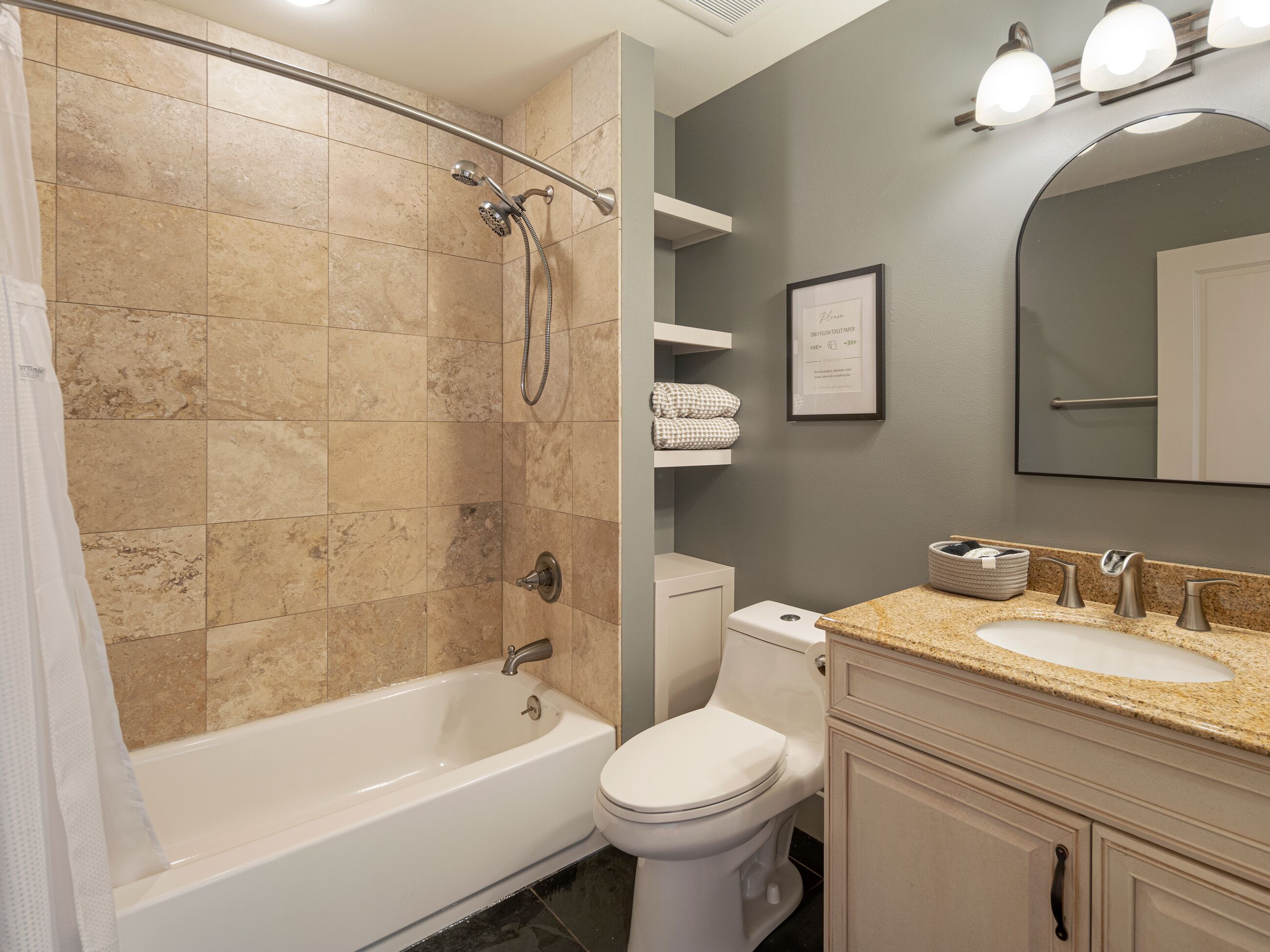 A bathroom with a bathtub, toilet, sink, and shower.