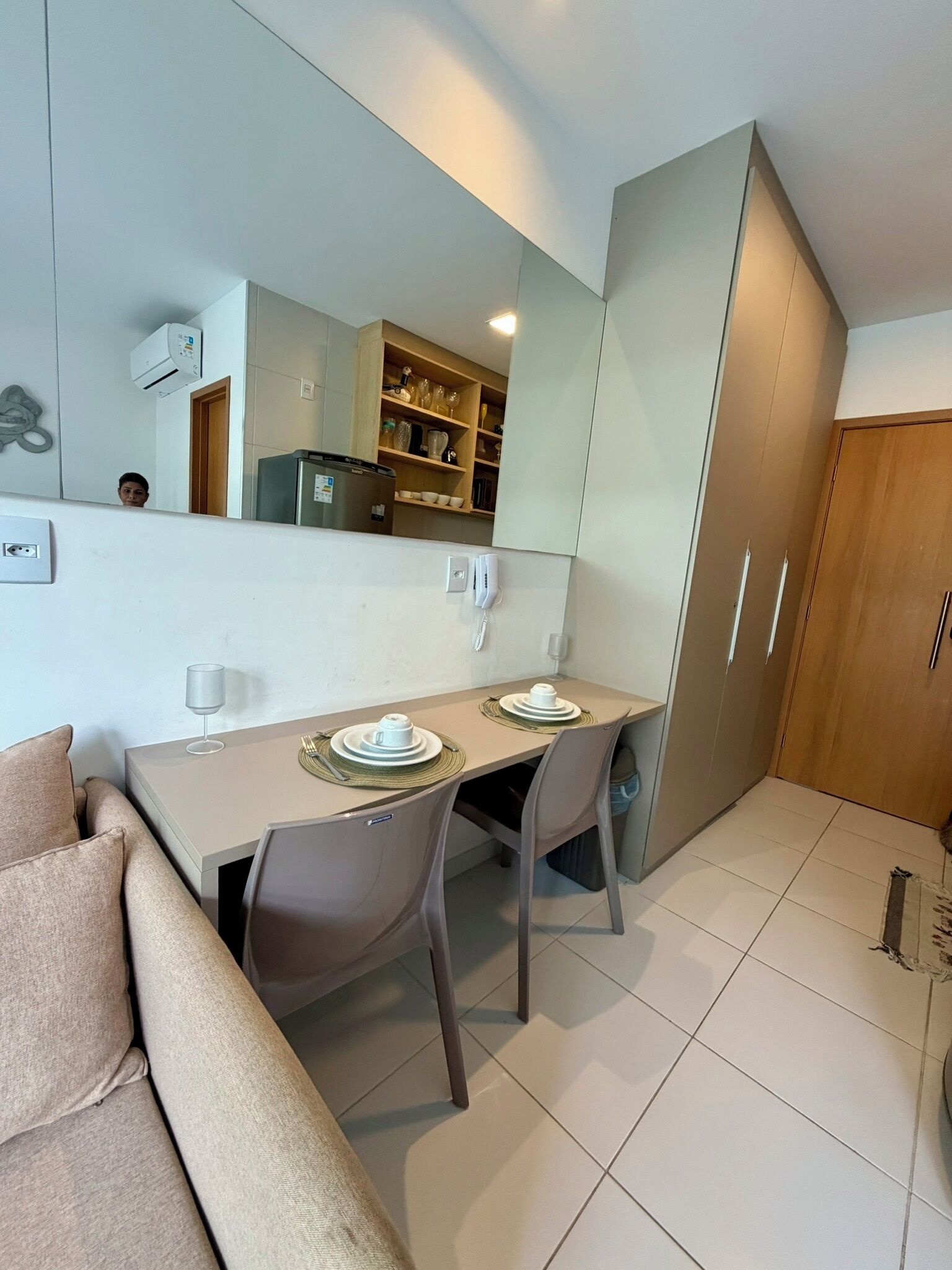 A modern kitchen with a dining table, chairs, and a built-in oven.