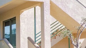 A building with a stone staircase, a balcony, and a window. - Astra Beach Studio 2 (Pylos-Nestoras)