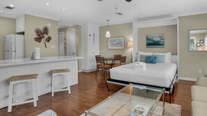 A hotel room with a bed, a small dining area, a kitchen, and a living area. - Seagrove Charm + Free Activity Tickets: Bikes, Dolphin Cruise & More! (Santa Rosa Beach)