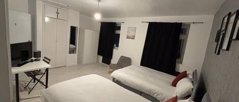 Family Room, Garden View | In-room safe, desk, laptop workspace, iron/ironing board