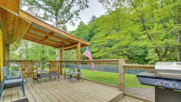 Enjoy al fresco dining on the deck, which features a grill and comfortable seating.