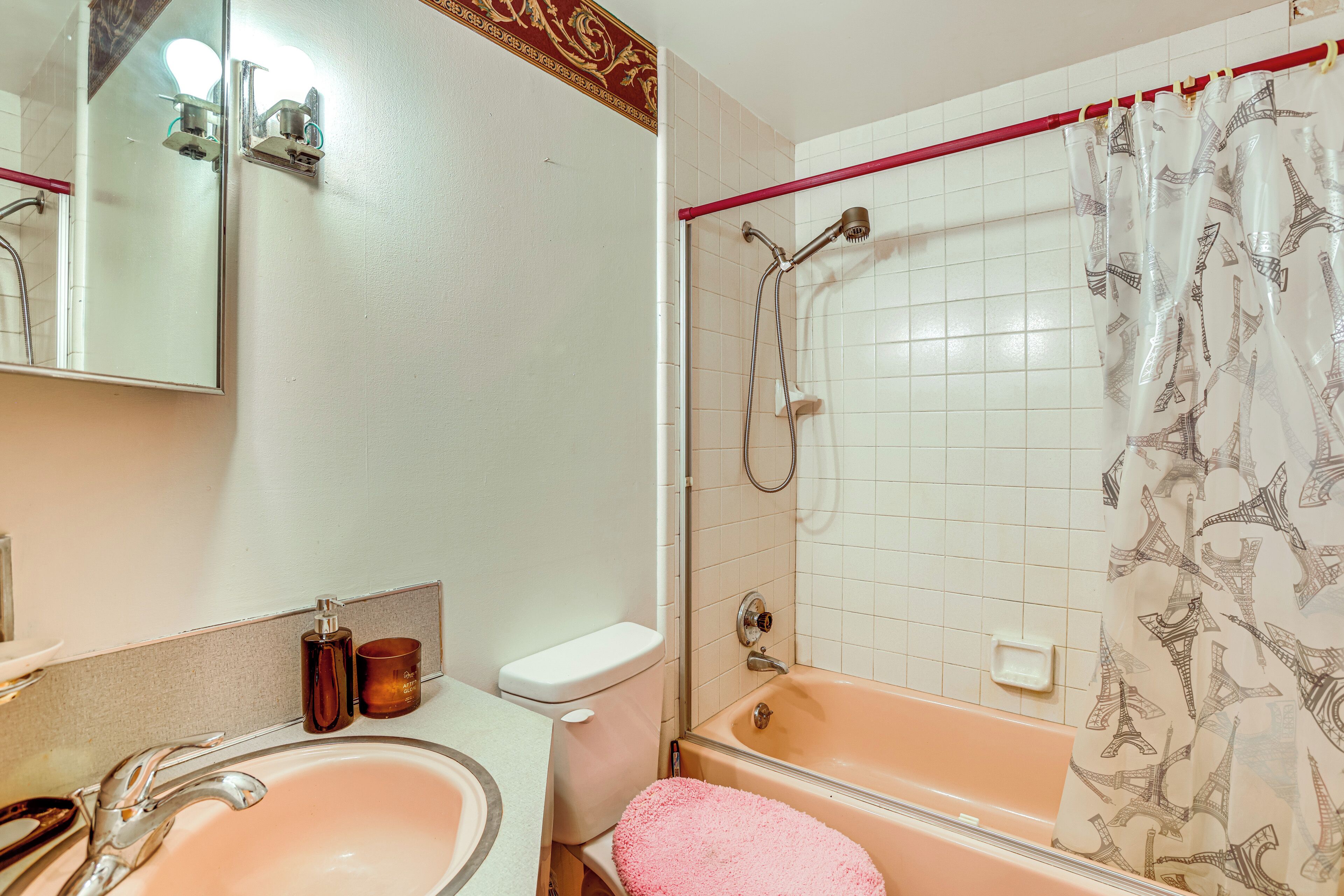 A bathroom with a sink, toilet, and bathtub.