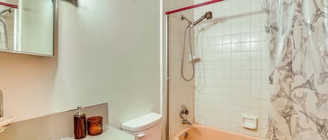 A bathroom with a sink, toilet, and bathtub.