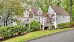 A two-story house with a front porch and a staircase leading to the second floor. - 1 Mi to Mohegan Sun: Studio w/ Pool Access (Norwich)