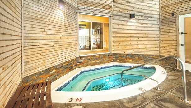 A wooden interior with a hot tub, a ceiling fan, and a window. - 1 Mi to Mohegan Sun: Studio w/ Pool Access (Norwich)