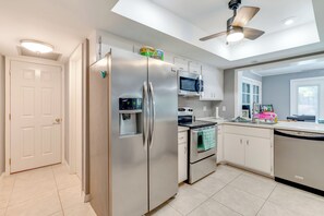 A modern kitchen with stainless steel appliances, a microwave, and a dishwasher.