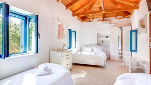 A modern bedroom with a wooden ceiling, a large bed, a bedside table, a dresser, and a wardrobe. - Beach House Steps Away From the sea (Pylos-Nestoras)
