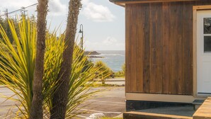 A wooden building with a view of the ocean. - Little Beach Resort (Ucluelet)