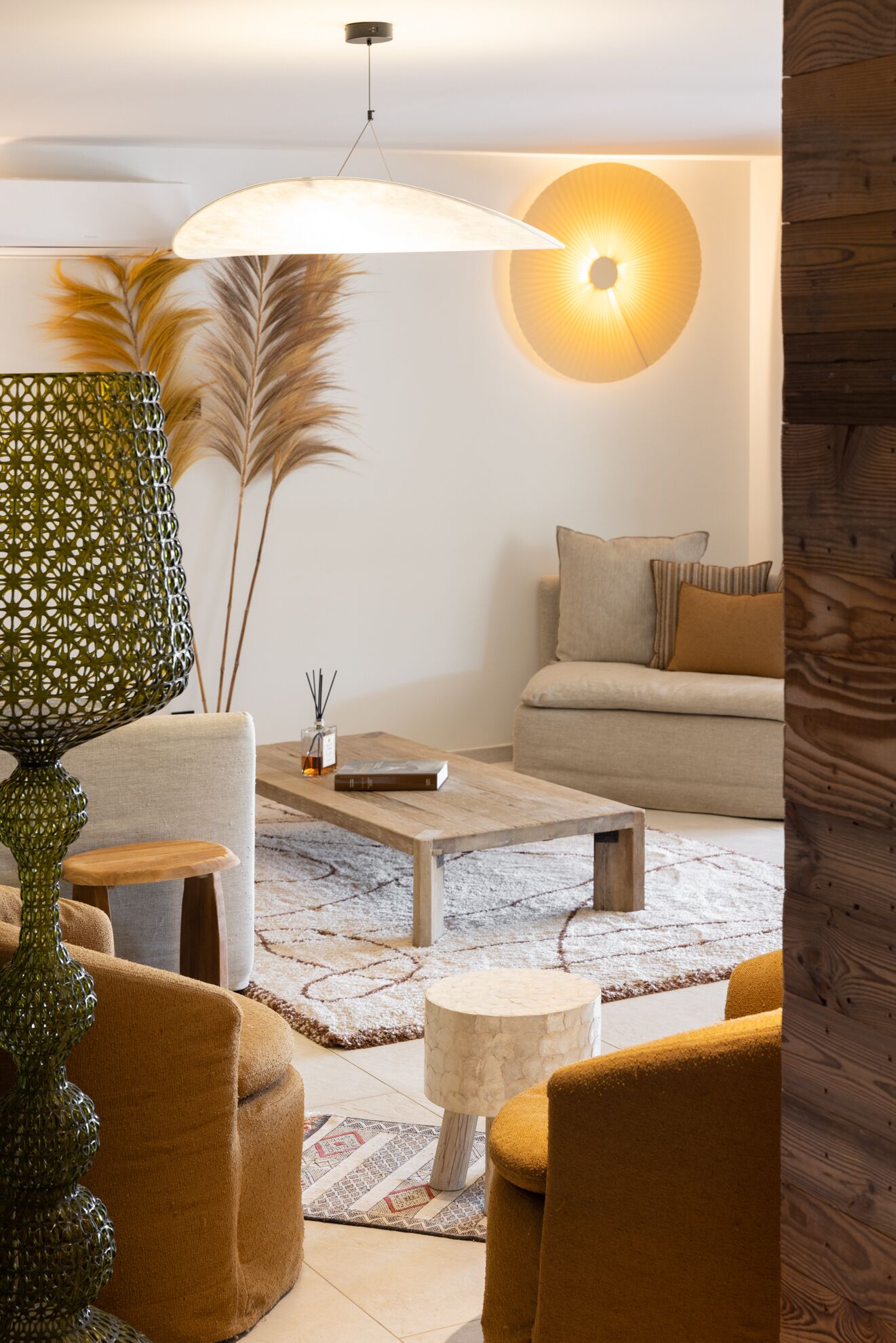 A living room with a sofa, coffee table, and decorative lamps.