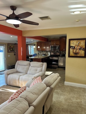 Relax in a cozy living space with a plush sofa, kitchenette, and stylish ambiance.