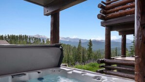 A hot tub with a view of mountains and trees. - Saddle Ridge B5 3 Bedroom Townhouse (Big Sky)