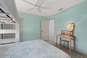A bedroom with bunk beds, a desk with a lamp, and a door leading to another room. - ☀️ Fun Outdoor Area🐾Pet Friendly🐾Shared Pool + Spa | Monty's Place☀️ (Fort Myers Beach)