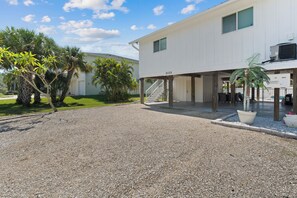 A building with a gravel driveway, a staircase leading to a covered entrance, and a sign indicating 'LOT 21172'. - ☀️ Fun Outdoor Area🐾Pet Friendly🐾Shared Pool + Spa | Monty's Place☀️ (Fort Myers Beach)