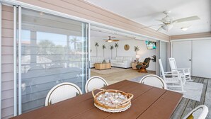 A spacious patio with a dining table, chairs, and a ceiling fan. - ☀️Private Pool, Fun Outdoor Area🐾Pet Friendly🐾Vallie's Villa & Monty's Place☀️ (Fort Myers Beach)