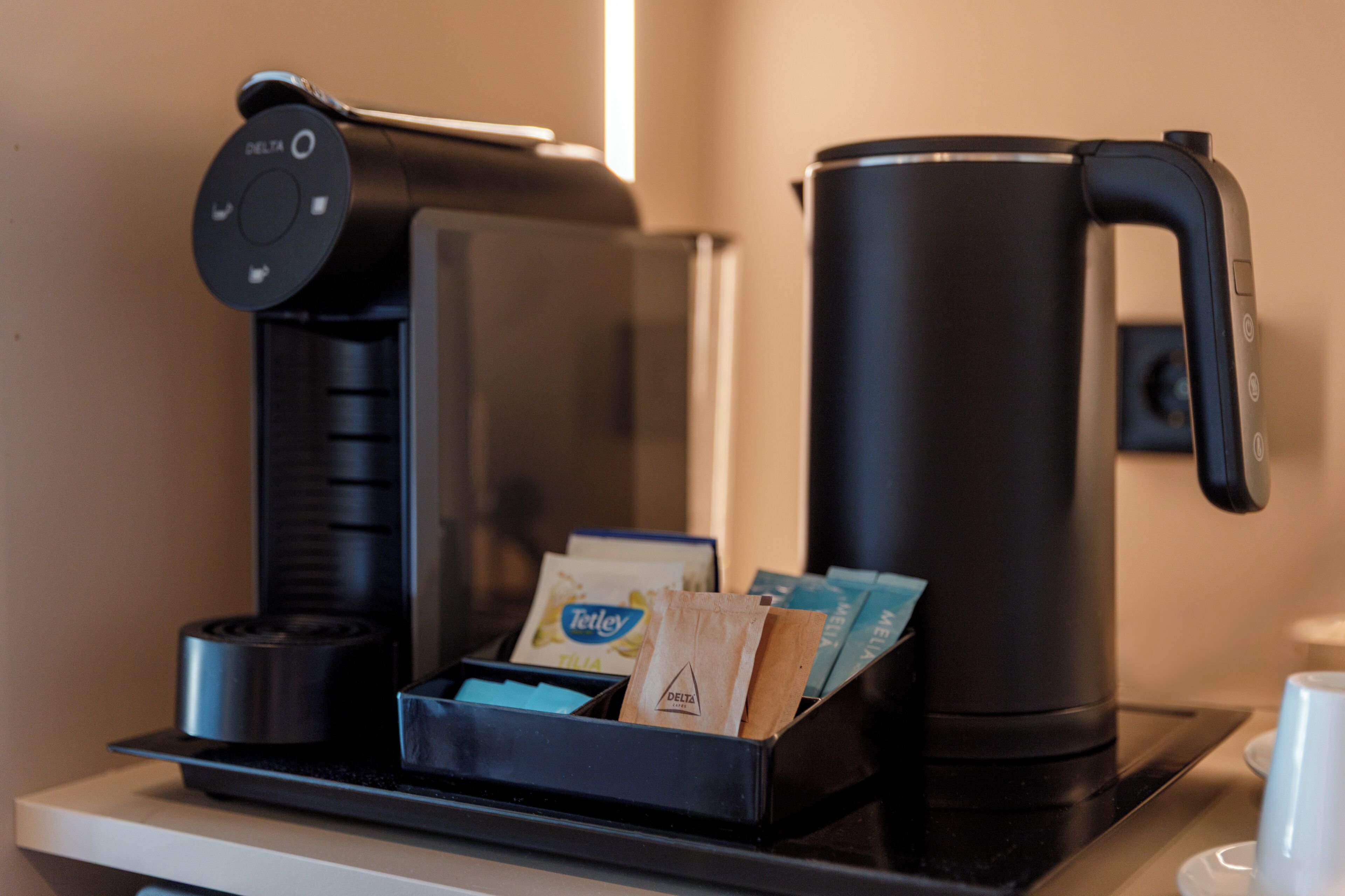 A coffee machine with a control panel and a coffee pot on a countertop.