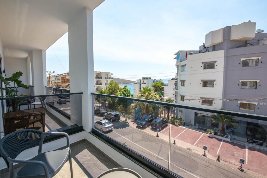 A balcony with a view of a street and buildings.