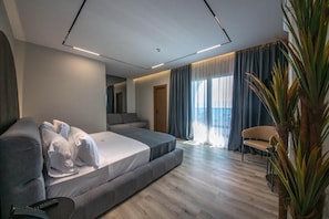 Junior Suite, Balcony, Sea View | Minibar, in-room safe, desk, blackout drapes