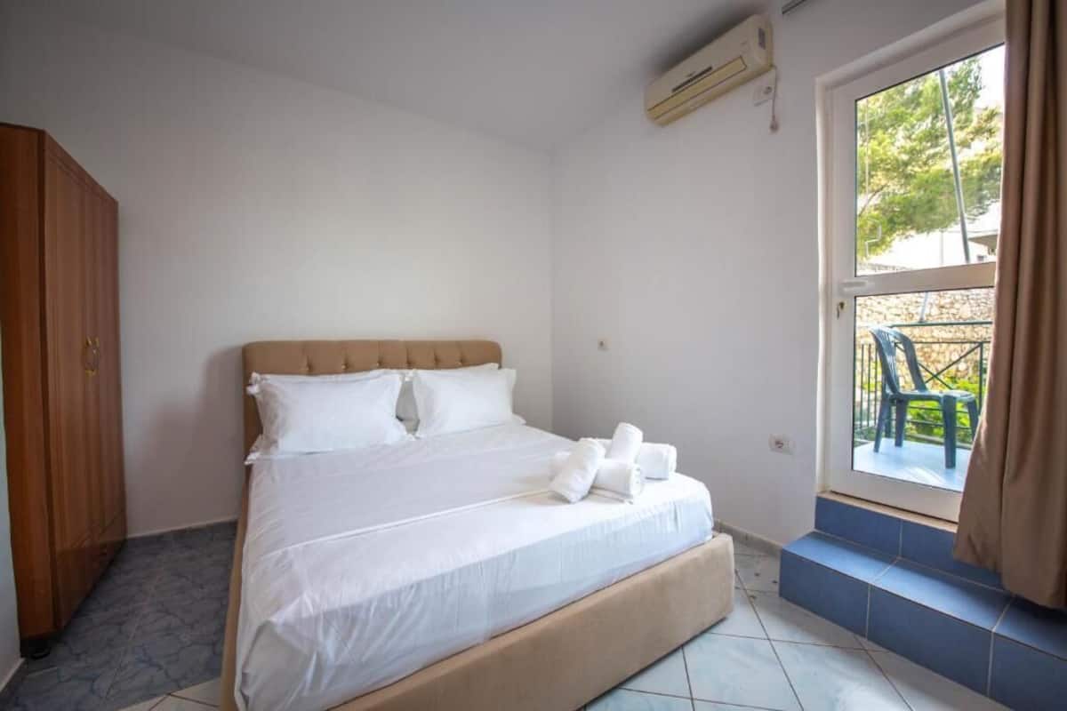 Une chambre à coucher avec un lit, une armoire et une fenêtre donnant sur l’extérieur.