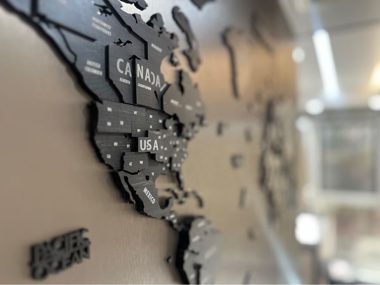 A wall with a map of North America, highlighting Canada, USA, and Mexico.