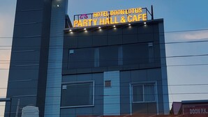 A building with a sign for 'Hotel Doon Lotus Party Hall & Cafe'. - Hotel Doon Lotus (Dehradun)