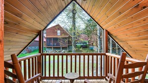 A wooden deck with a table and chairs, a view of a house, and a wooden ceiling. - Resort Pool Fitness Room Hot Tub Jacuzzi (Gatlinburg)
