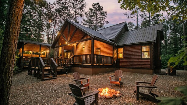A log cabin with a deck, outdoor seating, and a fire pit. - River Song- 1BR-Timber Creek Trails-Creekside (broken bow)