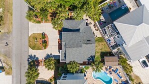 A residential property with a swimming pool, a covered patio, and a landscaped garden.