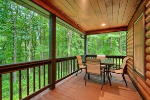 A wooden deck with a table and chairs, overlooking a forested area. - Oak Ridge Preserve | Hocking Hills, Nature Reserve (Rockbridge)