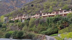 A hillside villa with multiple buildings, surrounded by lush greenery and mountains. - View of Larian Triangle (Menaggio)