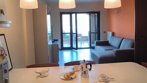 A dining area with a table set for two, a coffee maker, and a plate of bananas. - View of Larian Triangle (Menaggio)
