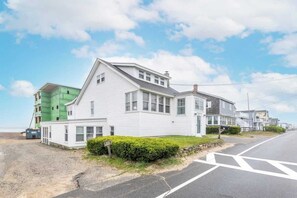 A two-story house with a garage, a driveway, and a well-maintained lawn. - The Granite Harbor (Wells)