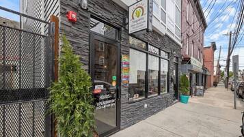A restaurant named 'La Milpa Taqueria' with a sign indicating it is open every day from 11:00 AM to 11:00 PM.