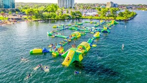 A water park with inflatable play structures and swimming areas.